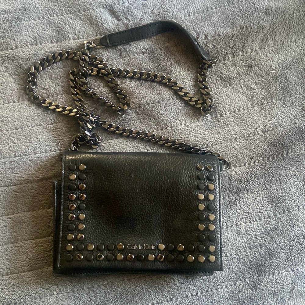Black Leather Calvin Klein purse  with gun metal black studs and chain strap.